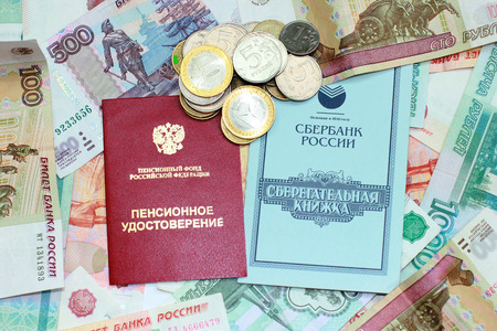 Pension certificate, passbook and money closeupの写真素材