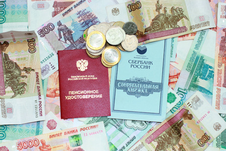 Passbook and pension certificate lie on the Russian moneyの写真素材