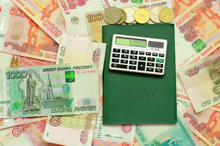 Calculator and employment history are on the Russian moneyの写真素材