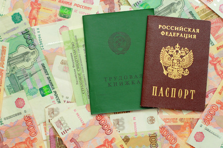 Employment records, passport and certificate of insurance are on the Russian moneyの写真素材