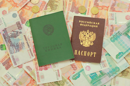 Work-book and a Russian passport lie on Russian money close upの写真素材