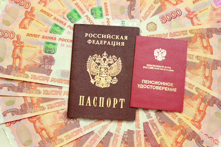 Russian passport and a pension certificate on the background of five thousandth moneyの写真素材