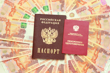 Russian passport and a pension certificate on the background of five thousandth moneyの写真素材