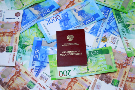 Pension: Pension certificate against the background of moneyの写真素材