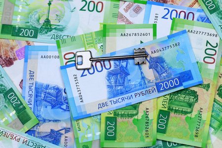 The keys to the apartment and the new banknotes. Close-up.の写真素材