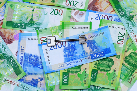 The keys to the apartment and the new Russian money. Close-up.の写真素材