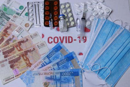 Antibiotics and virus pills against the background of Russian money and protective masks.の写真素材