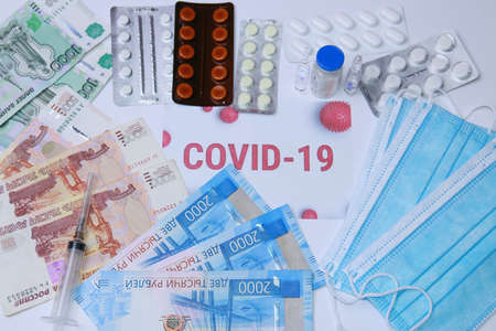 Antibiotics and virus pills against the background of Russian money and protective masks.の写真素材