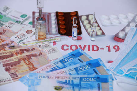 Coronavirus and the flu epidemic. Mercury thermometer, antibiotic, protective mask, pills and Russian money.の写真素材