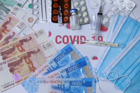 medicines against coronavirus. Various pills, a syringe, a thermometer, masks, antibiotics and Russian money.の写真素材