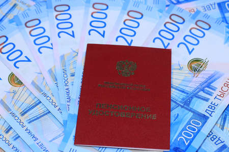 Pensioner's certificate and tablets on paper banknotesの写真素材