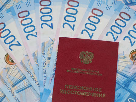 Pension certificate against the background of Russian moneyの写真素材