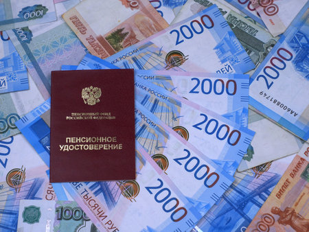 Pension certificate against the background of Russian moneyの写真素材