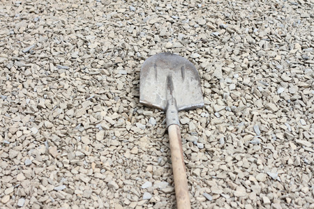 The iron shovel lies on crushed stoneの写真素材