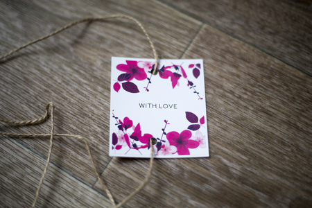 The card with florets and the inscription With love, lies against the background of, tied up by a...