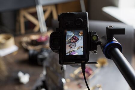 cake photo via the camera screen. a pie piece on a casket. blue backgroundの写真素材