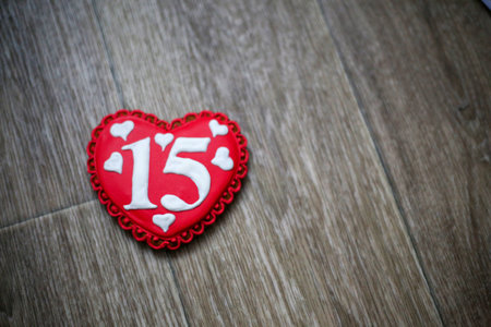 red ginger cookies in the shape of a heart with a white number 15.の写真素材