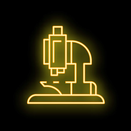 Yellow glowing neon line microscope icon isolated on black backgroundのイラスト素材
