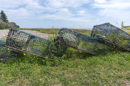 Lobster traps stacked onshore beside Bay of Fundy, New Brunswick, Canada.の写真素材