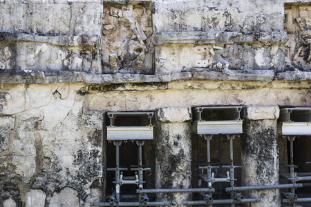 the weathered exterior wall of the ancient Mayan building ruins in Tulum, Mexicoの写真素材