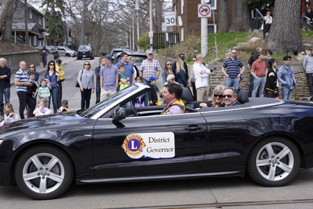 the District Governor takes part in the Beaches Easter Parade 2017 on Queen Street East Toronto.のeditorial素材