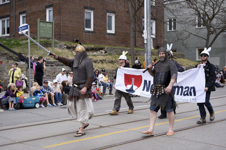 men in medieval costume march in the Beaches Easter Parade 2017 on Queen Street East Toronto.のeditorial素材