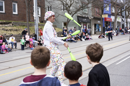 a juggler performs at the Beaches Easter Parade 2017 on Queen St. Eastのeditorial素材