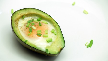 Avocado Baked with Egg on White Plate, Close upの写真素材