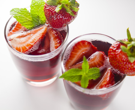 Summer drinks, two glasses of red fruit juice with strawberryの写真素材