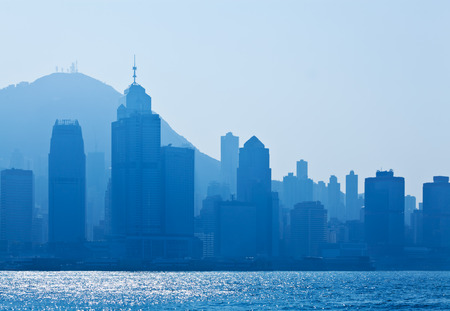 Silhouettes of skycrapers in Hong Kong , blue toneの写真素材