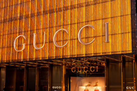 Hong Kong, China - August 21, 2011: Sign of Gucci store at Canton Road, Tsim Sha Tsui, Hong Kong, illuminated at night. Gucci is an Italian fashion and leather goods brand, part of the Gucci Group.のeditorial素材