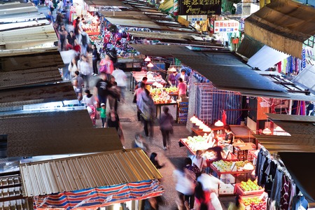 Hong Kong, China - November 16, 2011: Street vendors and people shopping in Fa Yuen Street, MongKok, Hong Kong. The street is full of vendors selling exotic fruits, vegetables and bargain-priced clothing.のeditorial素材