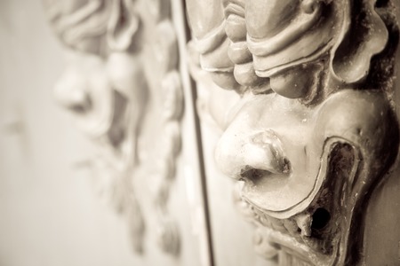 Toned image of a pair of Chinese lion carvings on the door of a castleの写真素材