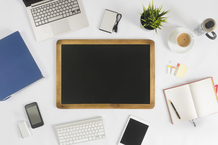Blank chalkboard with wooden frame on office deskの写真素材
