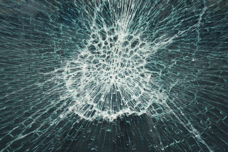 Close-up view of a broken glass window