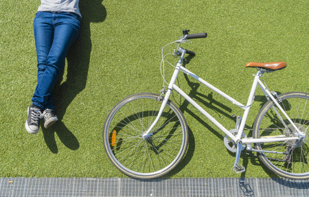 Top down view of vintage bike and cyclist on lawn