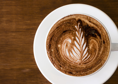 Top down view of cup of coffee with latte artの写真素材