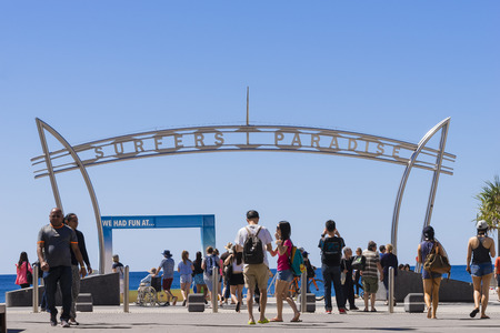 Gold Coast, Australia - September 22, 2016: View of many tourists crossing the road and the Surfers Paradise arch, the main entrance to the beach.のeditorial素材