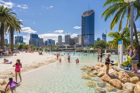 Brisbane, Australia - September 25, 2016: View of people swimming at the Streets Beach, inner-city and man-made beach, with skyscrapers in the background in South Bank, Brisbane.のeditorial素材
