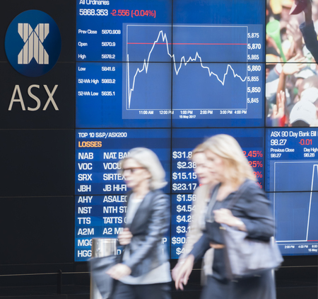People walking past the electronic display board of the Sydney Exchange Squareのeditorial素材