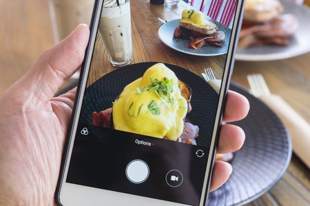 Taking picture of breakfast with smartphoneの写真素材