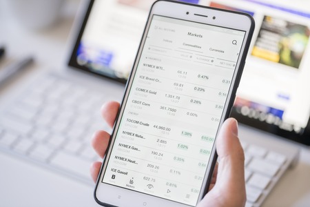 Checking commodity prices on a smartphoneのeditorial素材