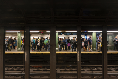 Passengers waiting for train in a subway station in New York City