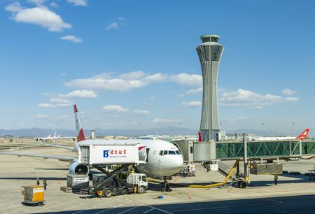 Beijing, China - Mar 14, 2019: Passenger plane docked at Beijing Capital International Airport before departure, in-flight meals being loaded onto the plane.のeditorial素材
