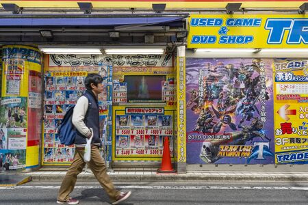 Man walking past a japanese game and DVD shop in Akihabara, Tokyoのeditorial素材