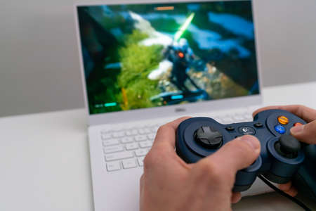 Playing game on laptop computer with joypad