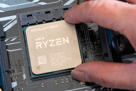 Close-up of installing third generation Ryzen processor on mainboardのeditorial素材