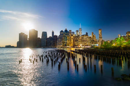 Composite image of Manhattan skyline from day to nightの写真素材