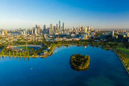 Aerial photo of beautiful park with lake and Melbourne CBD at sunriseの写真素材