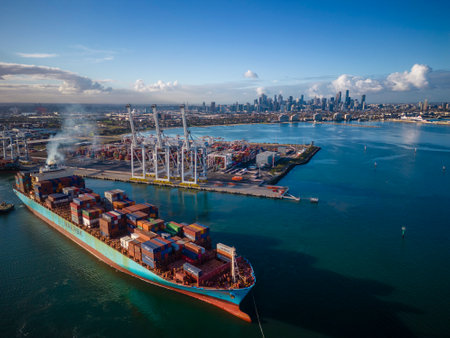 Melbourne, Australia - Jun 29, 2022: Aerial view of container ship departing from Port of Melbourne